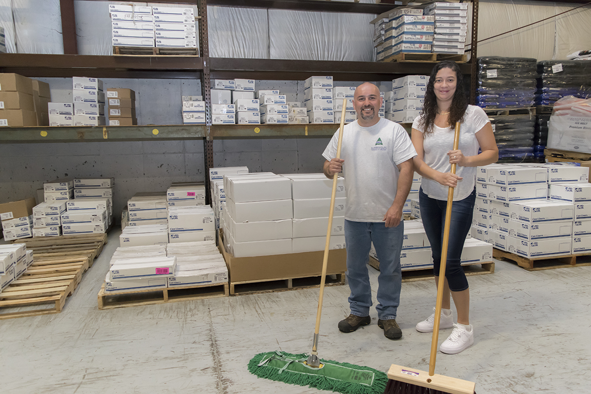 A few employees stand in our warehouse.