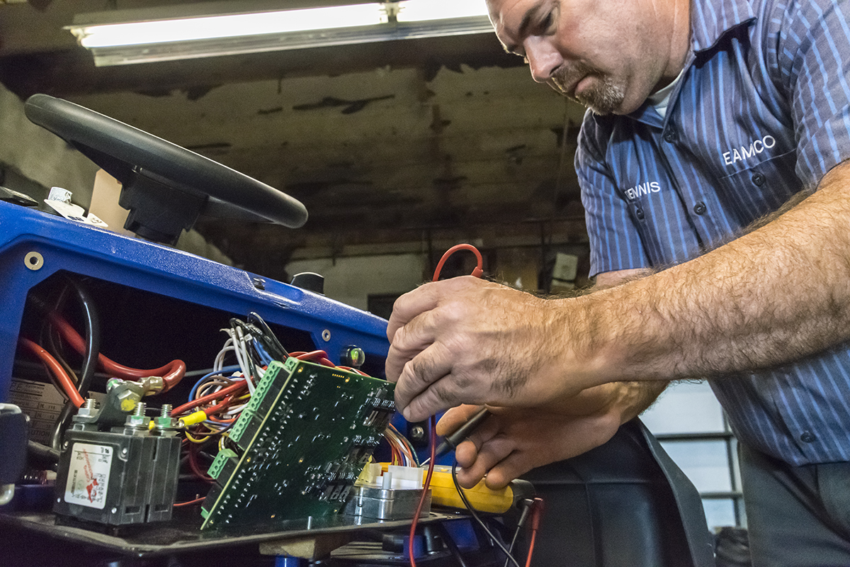 Dennis working on a machine.